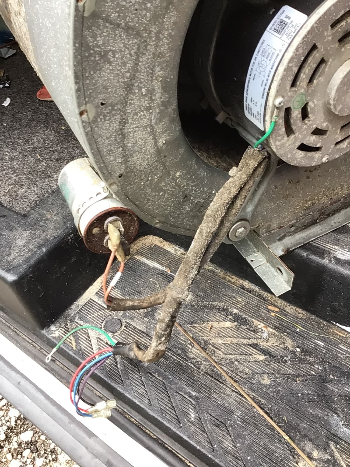 A dirty blower motor and housing inside an air handler before HVAC cleaning