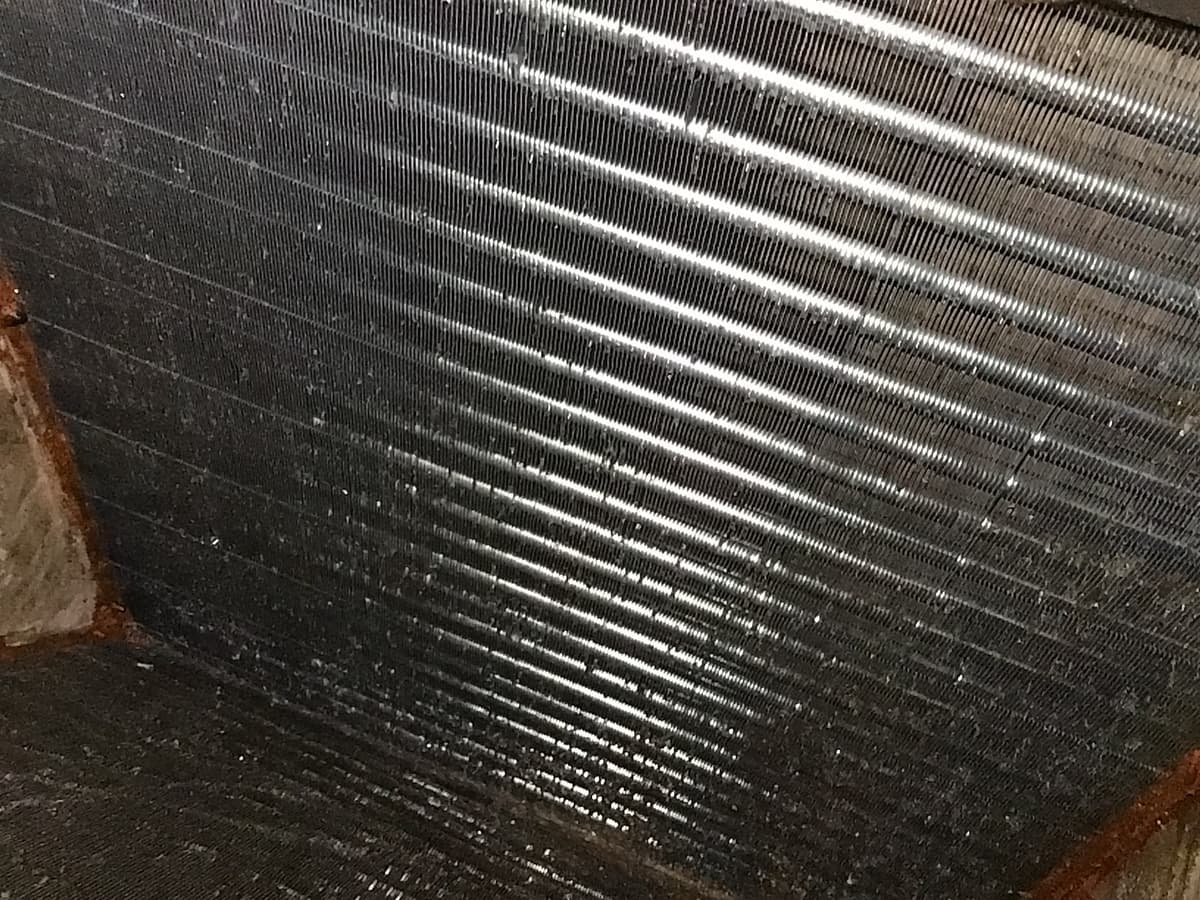 An evaporator coil with clean, straight fins after HVAC cleaning