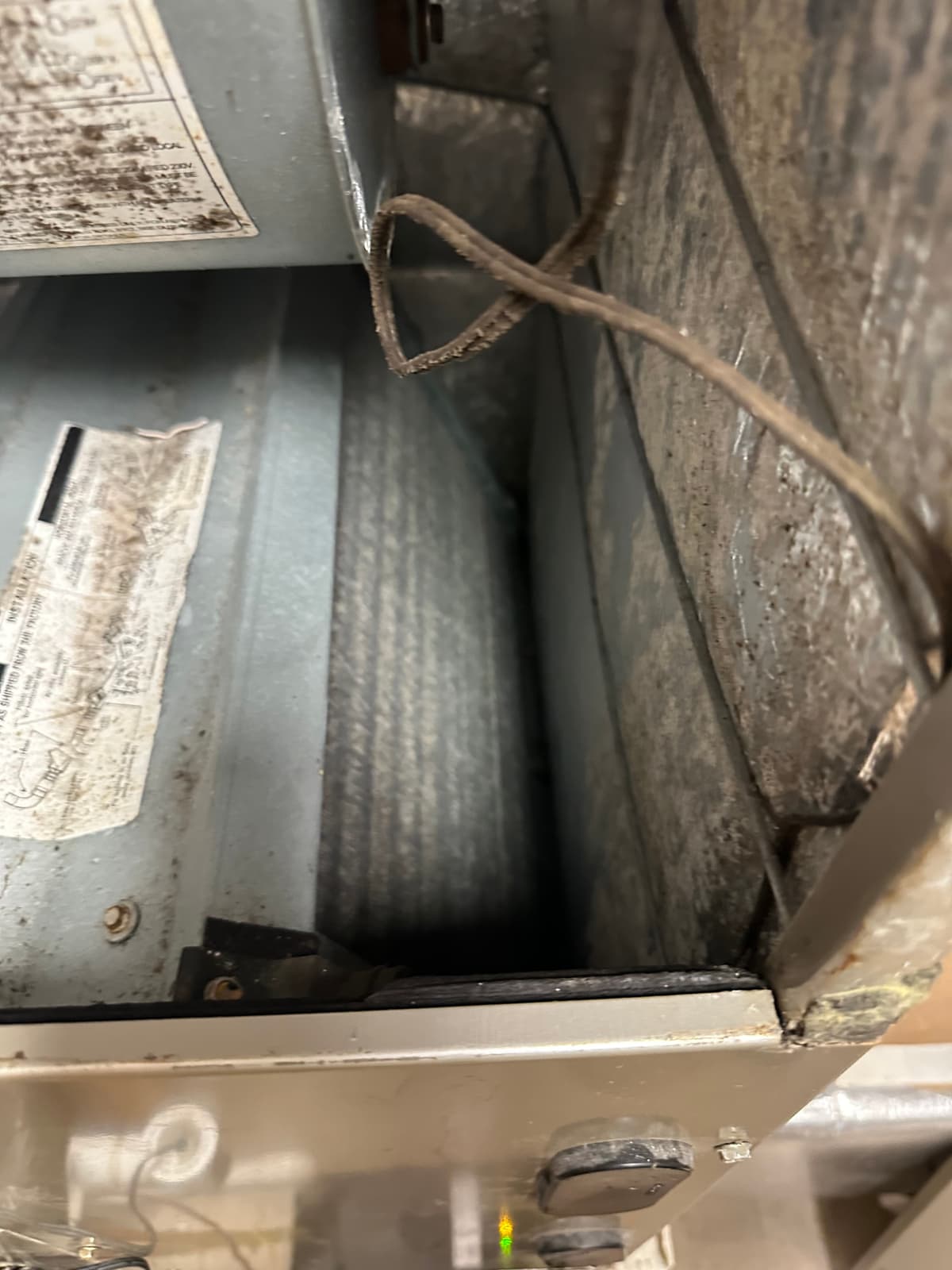 Dark growth and staining inside an HVAC air handler cabinet