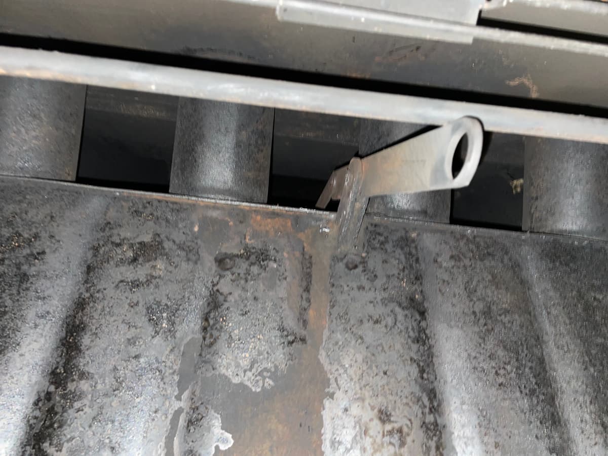 A fireplace damper after creosote was cleaned away