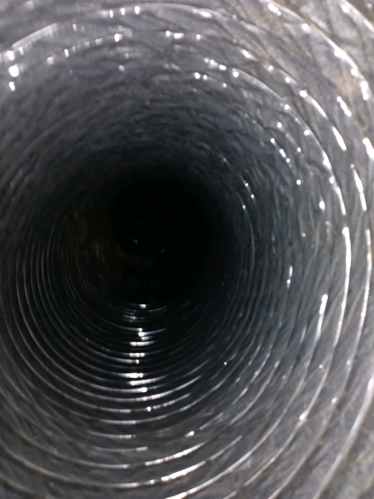 A flexible duct after cleaning, with a clean, shiny liner