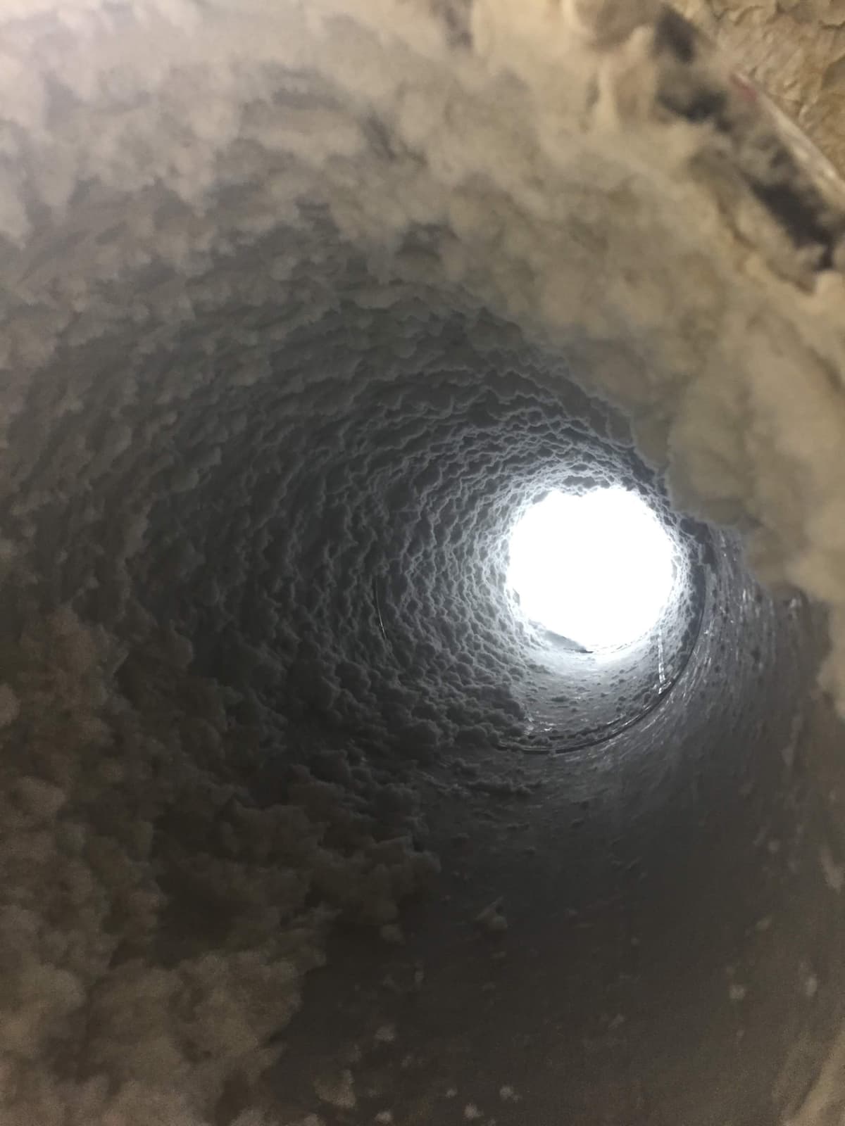 Looking down the inside of a large-diameter commercial dryer vent duct