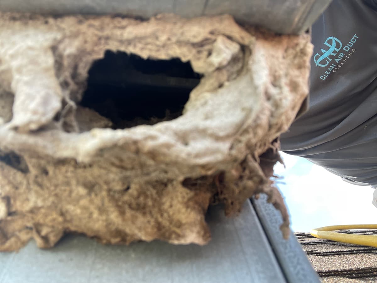 A roof dryer vent exhaust packed with lint before cleaning