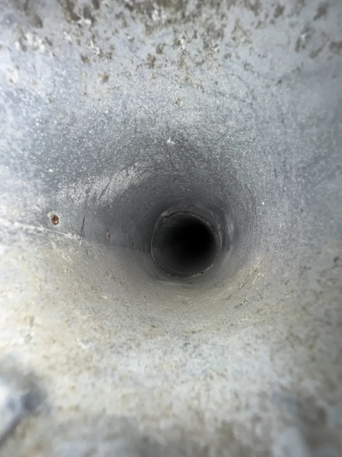The same riser after cleaning, the full bore of the duct open again to bare metal