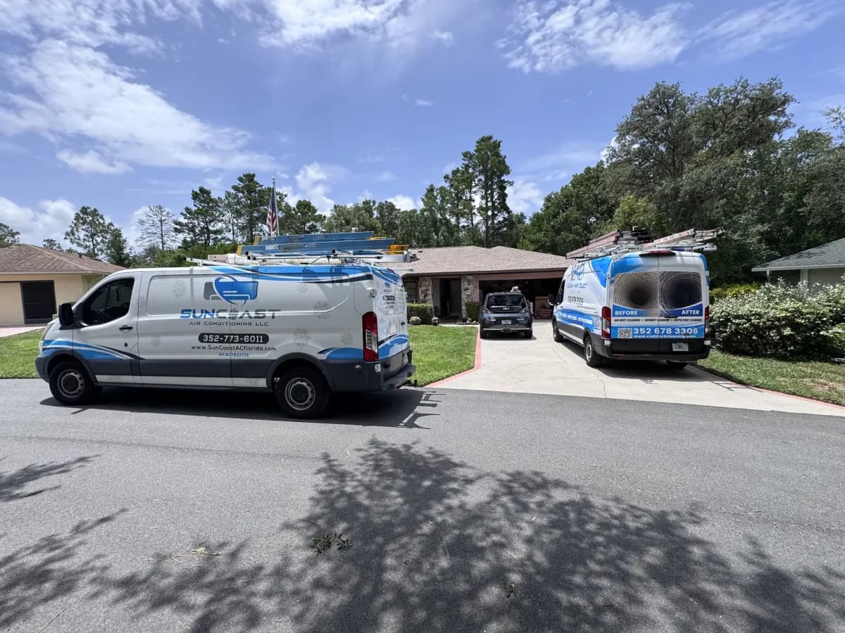 Two Clean Air Duct Cleaning vehicles working a single Central Florida site, the crew size a larger building needs
