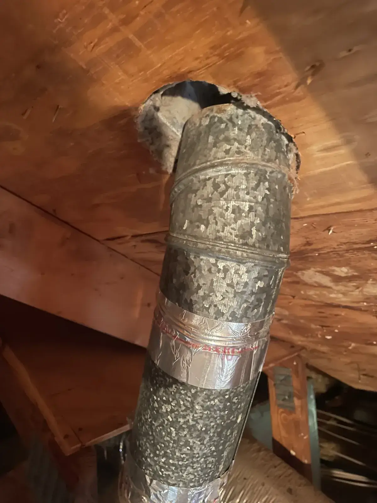 A duct left disconnected in an attic above the ceiling