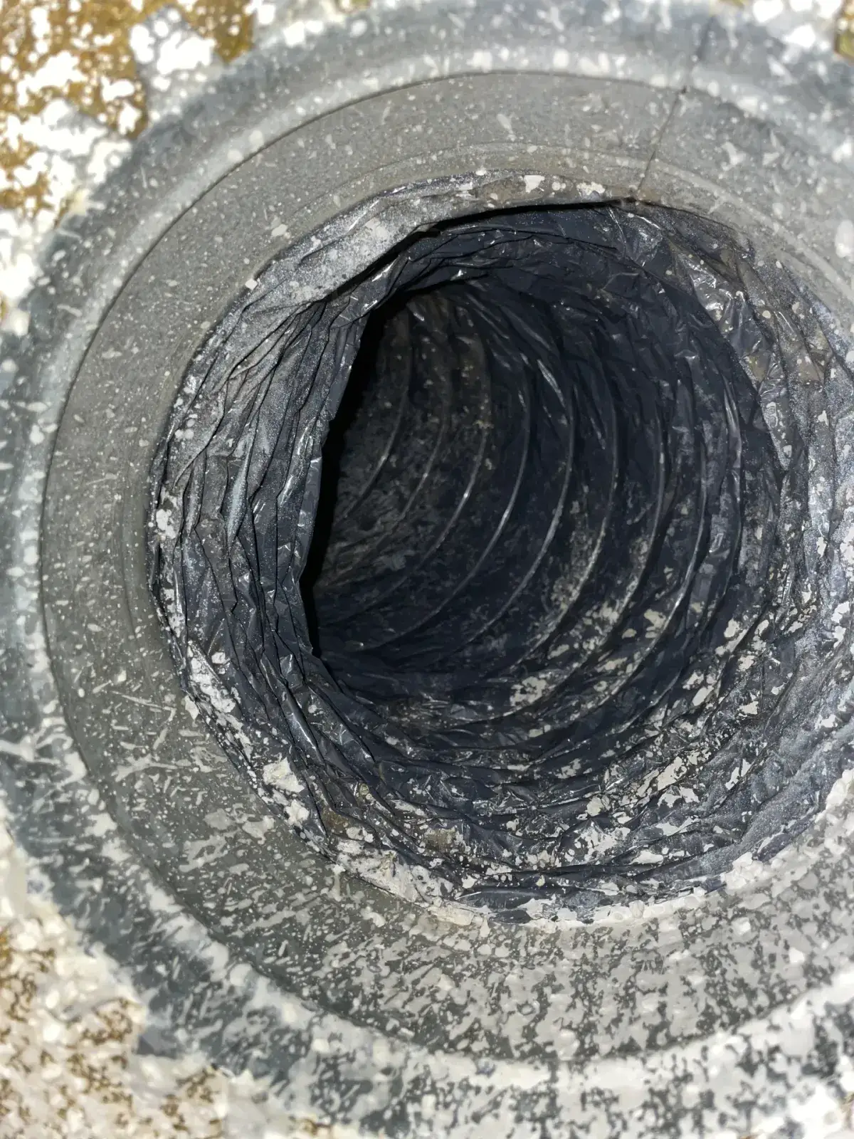 A damaged section of flexible duct found during a visit
