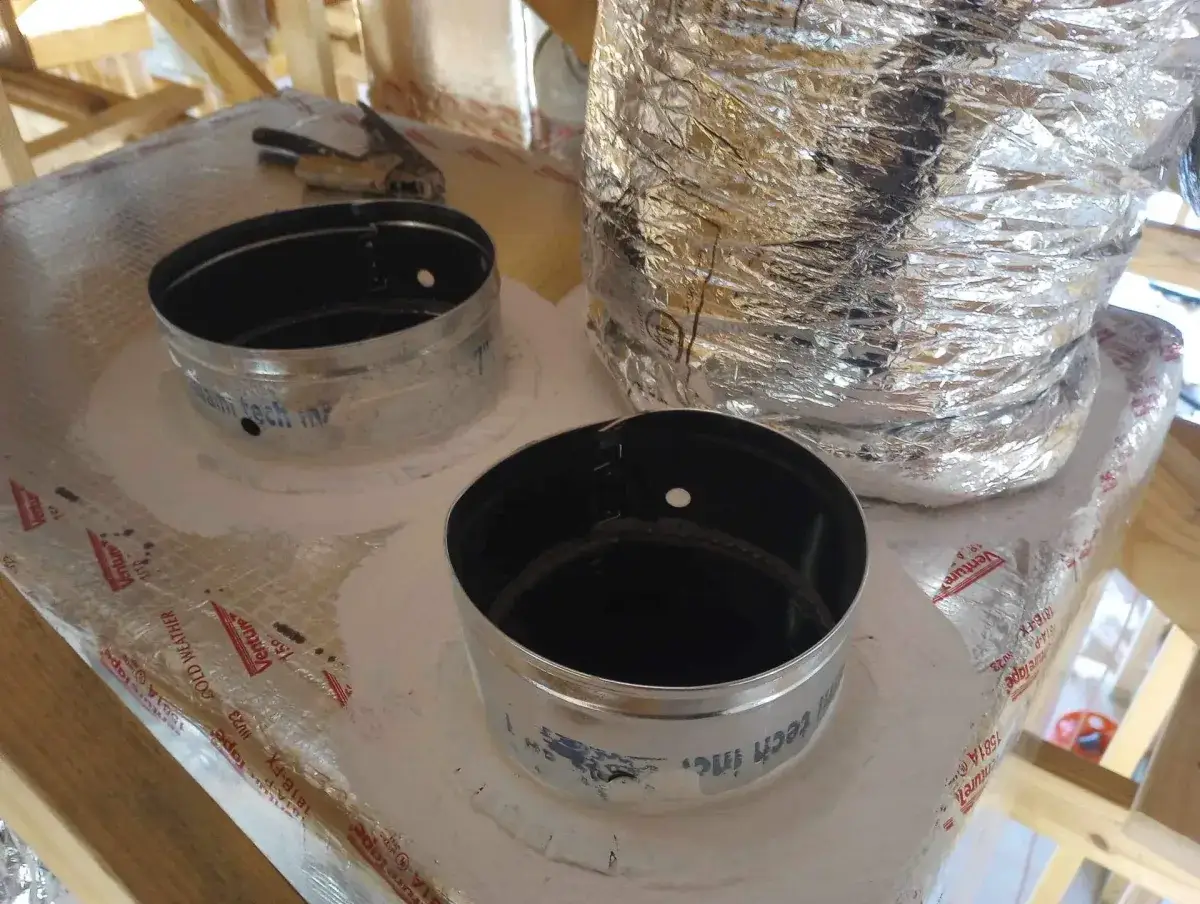 New duct parts and a length of flexible duct laid out for a repair