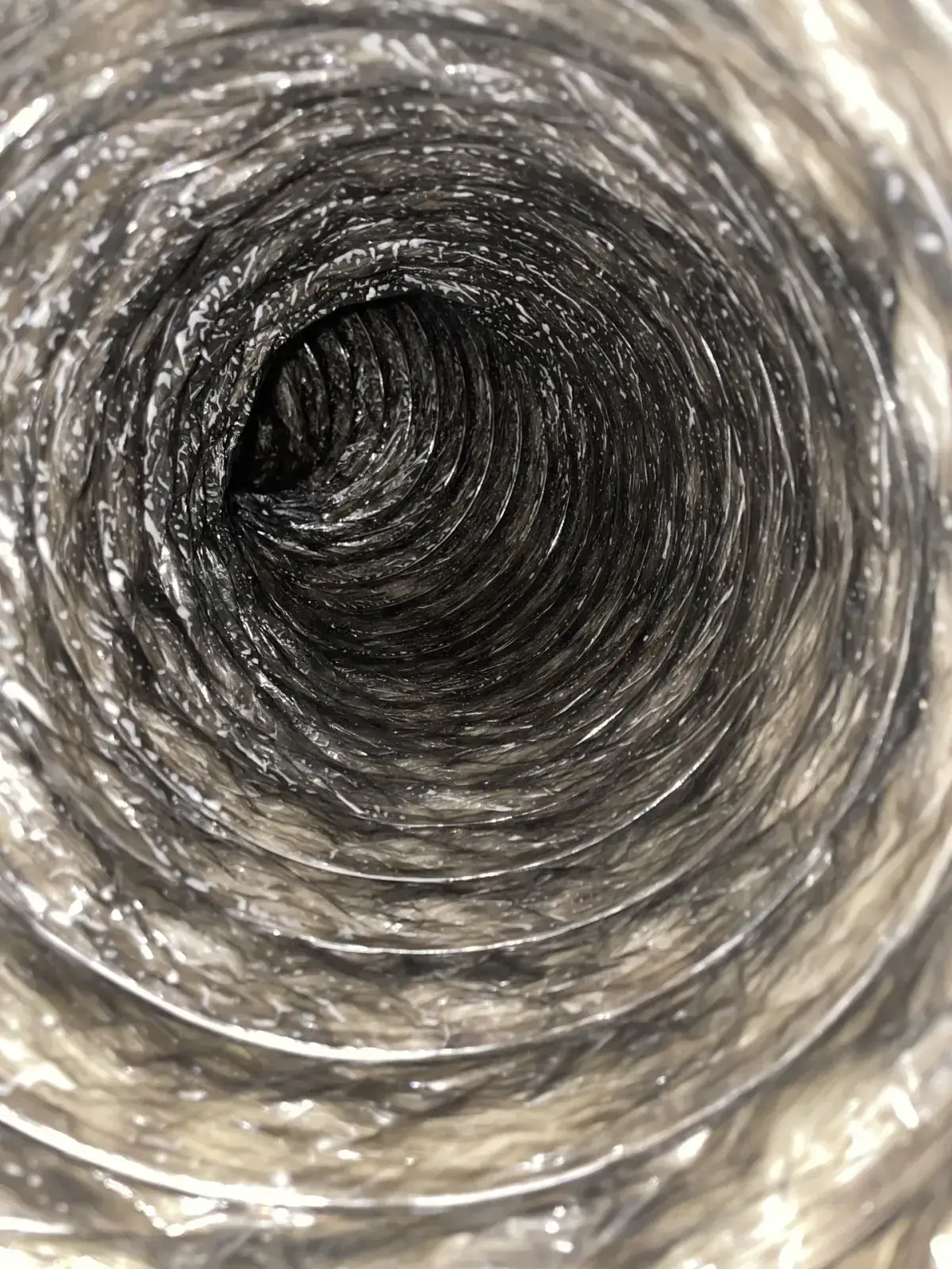 Dust clinging inside a silver-lined flexible duct