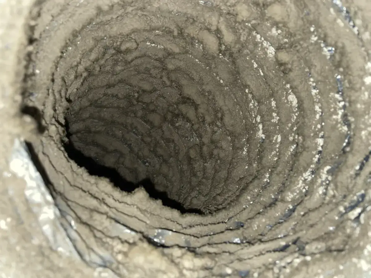 A torn flexible duct liner found during a cleaning