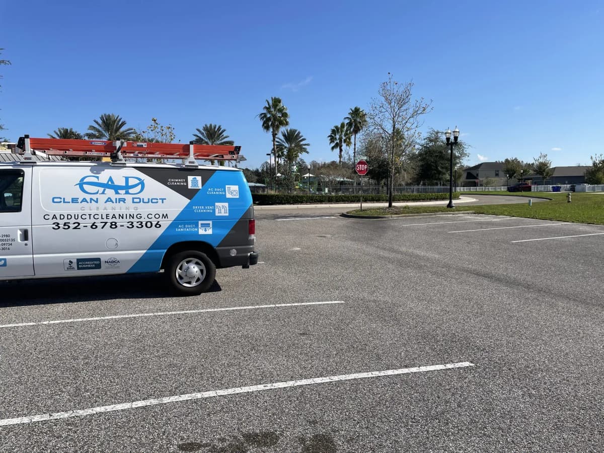A Clean Air Duct Cleaning van parked on a Central Florida job, ladders racked and ready