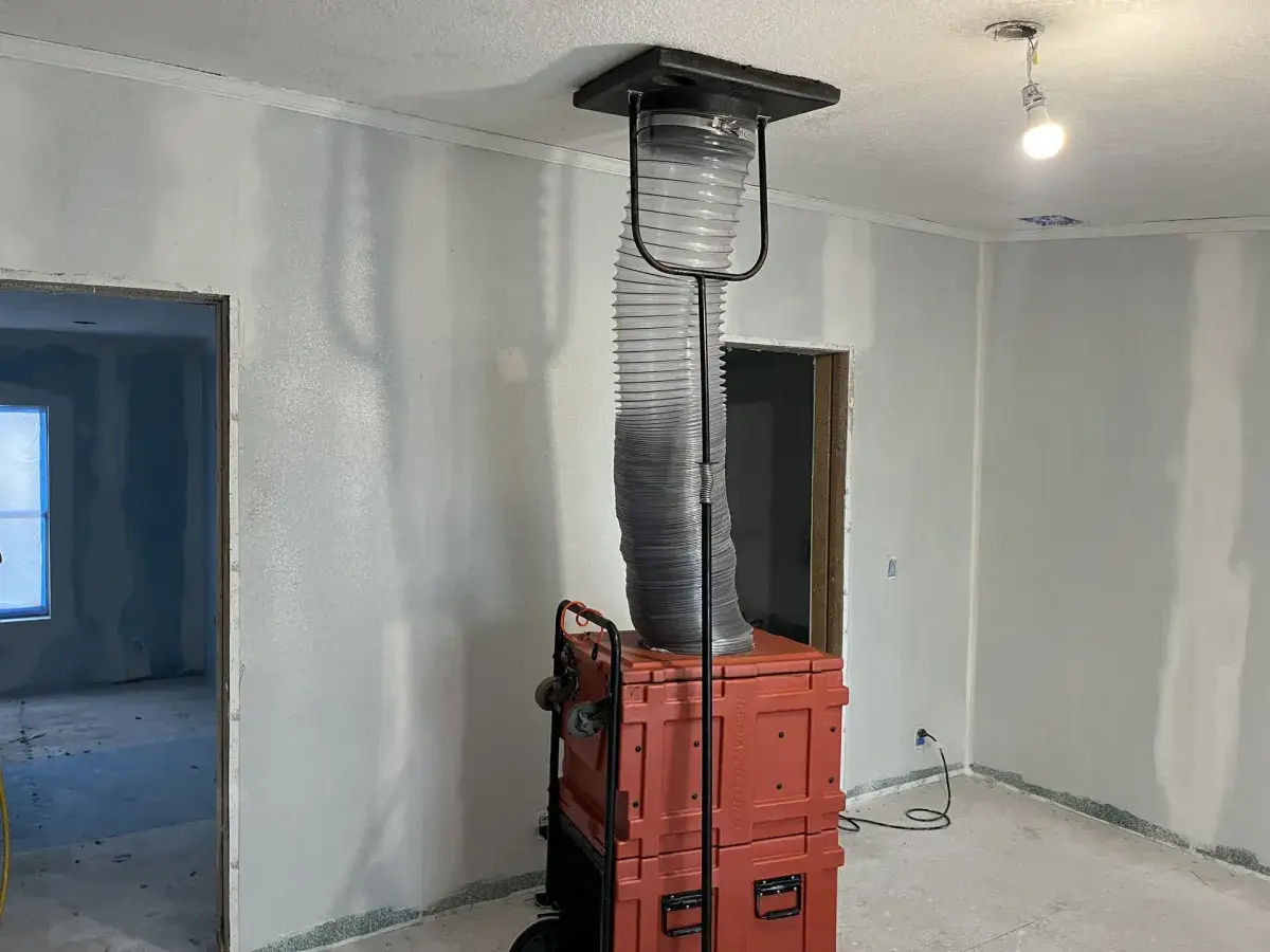 A negative air machine connected to the ductwork of an empty home