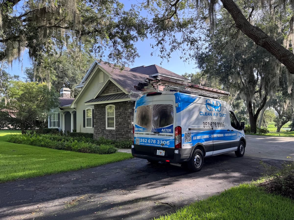 A branded Clean Air Duct Cleaning service van parked at a Central Florida property