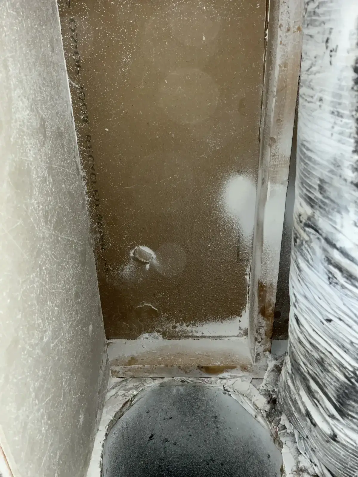 Rust and residue inside an air handler cabinet