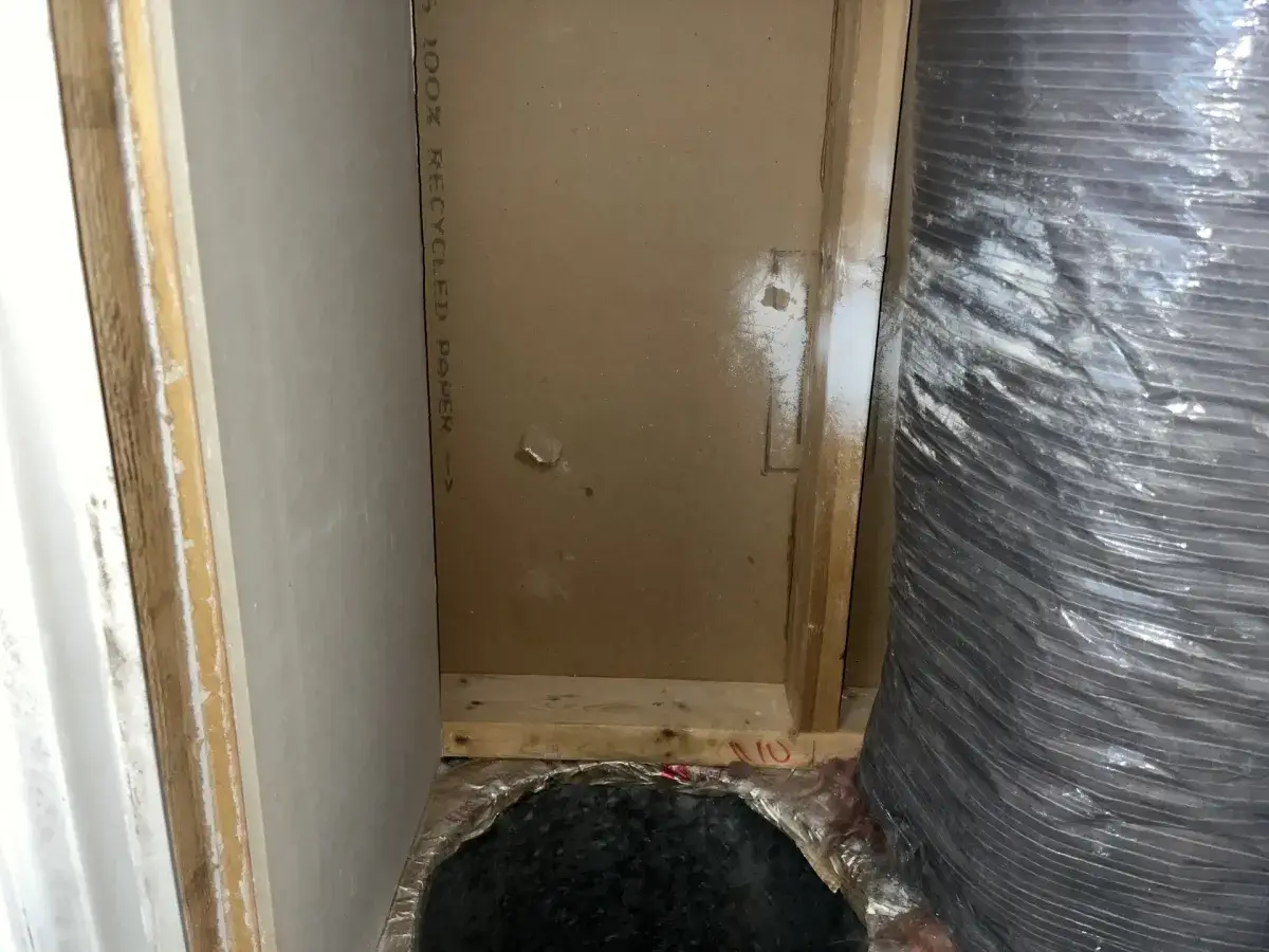 An air handler in a closet with the panel removed