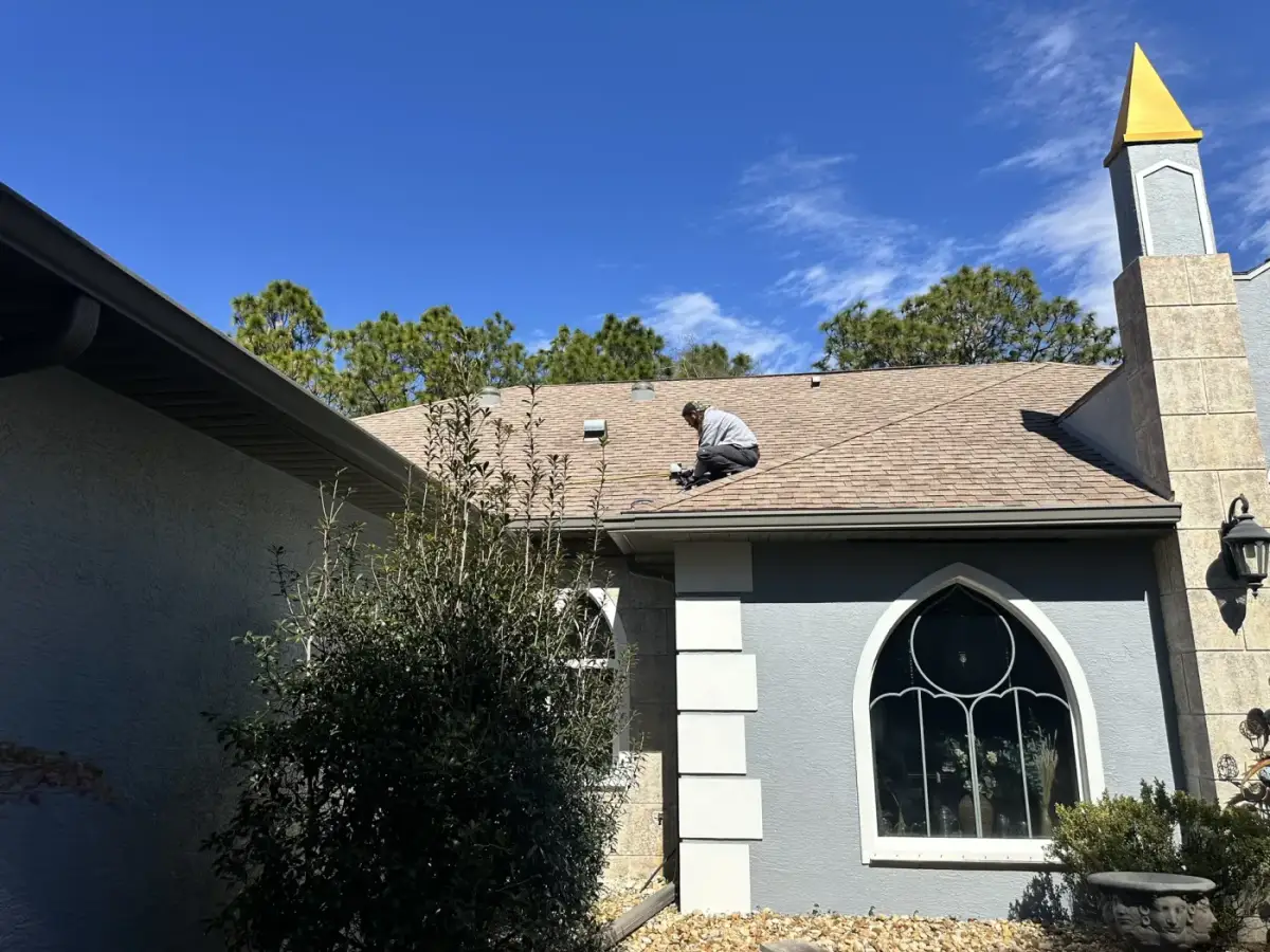A Clean Air Duct Cleaning van outside a home with an arched front window