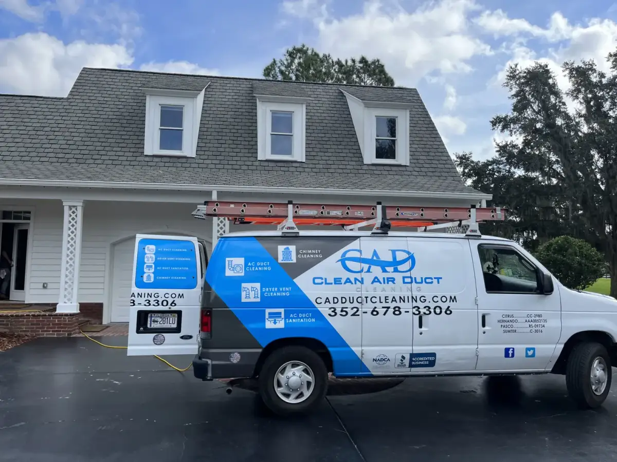 A Clean Air Duct Cleaning van outside a two-story home with dormer windows