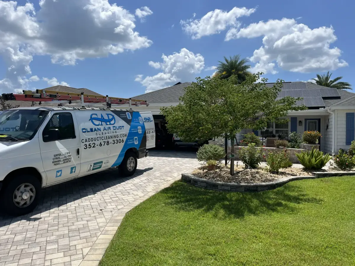 A Clean Air Duct Cleaning van parked outside a well-landscaped single-story Florida home