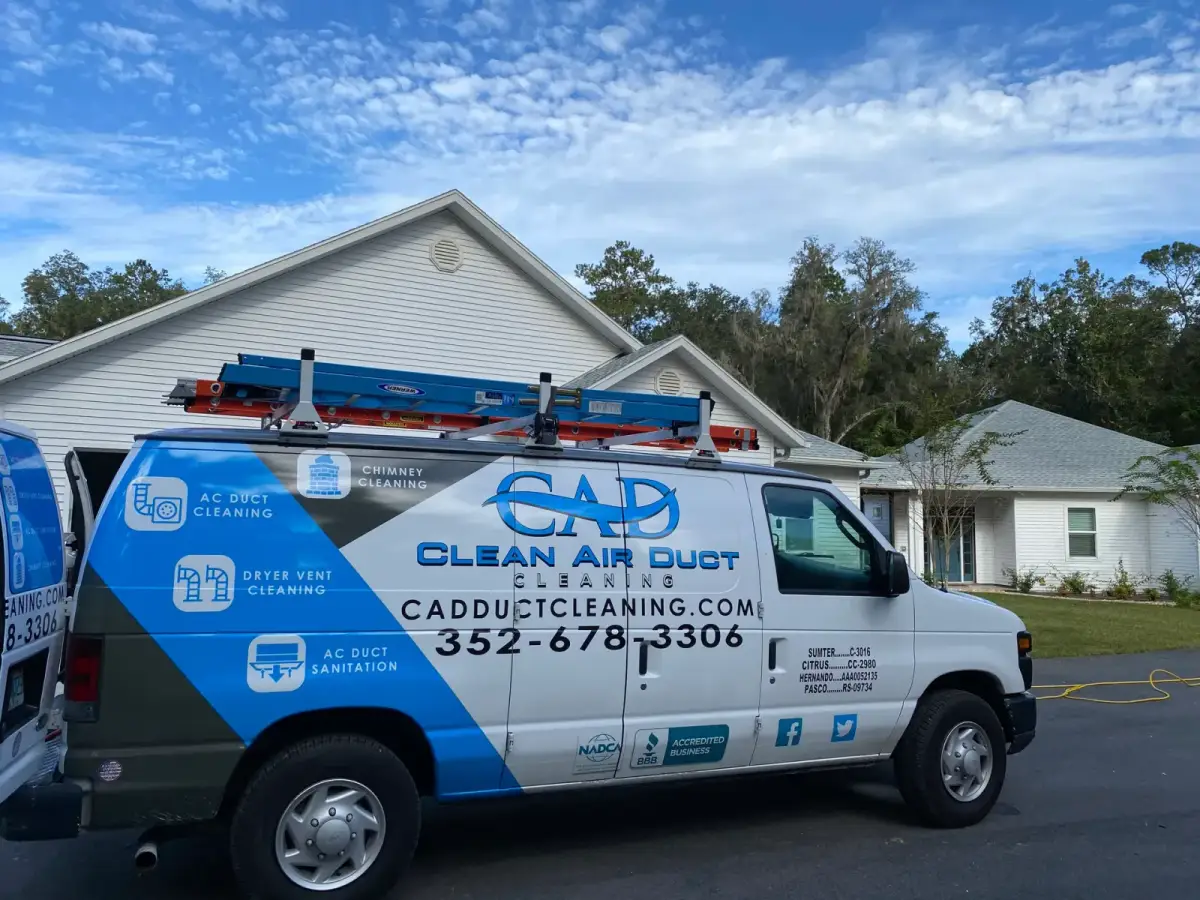 A Clean Air Duct Cleaning van parked in a neighborhood of single-story homes