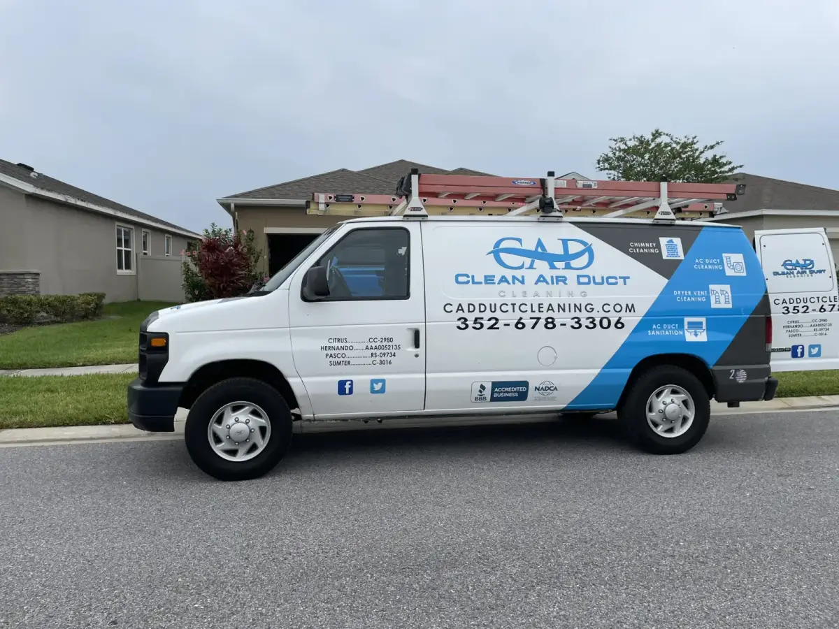 A Clean Air Duct Cleaning van outside a newly built home