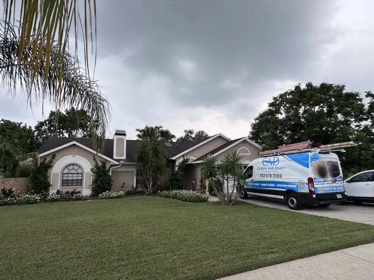 A Clean Air Duct Cleaning van outside a Florida home with palms in the front yard