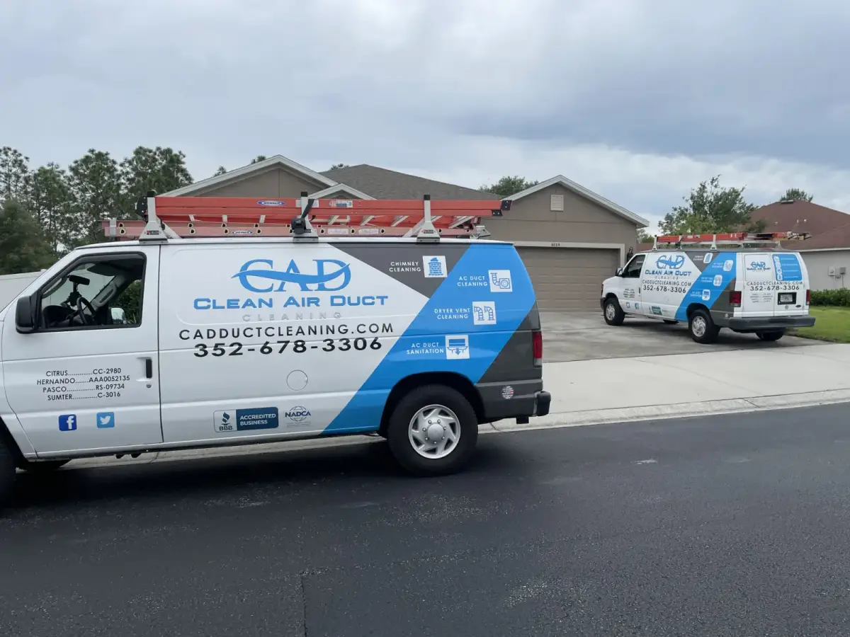 A Clean Air Duct Cleaning van parked on a quiet residential street