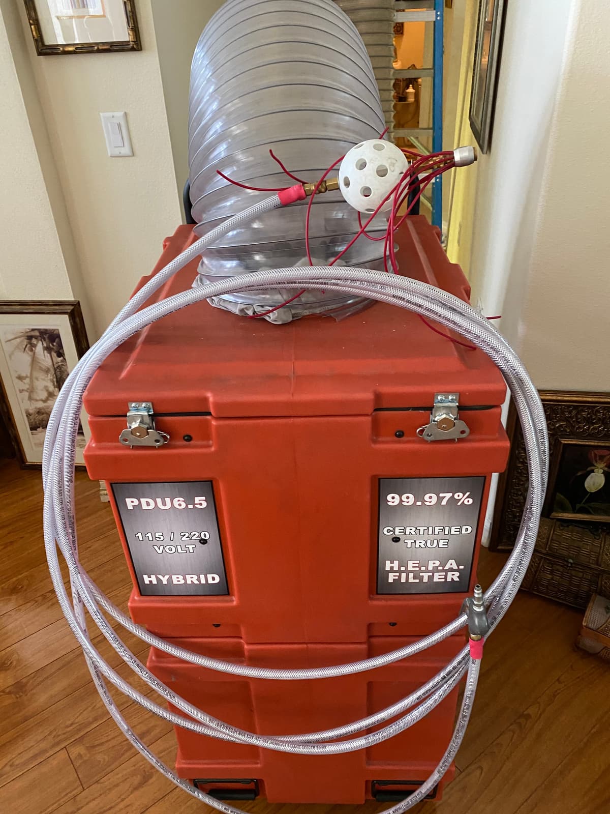 A HEPA-filtered negative air machine set up inside a home before duct cleaning
