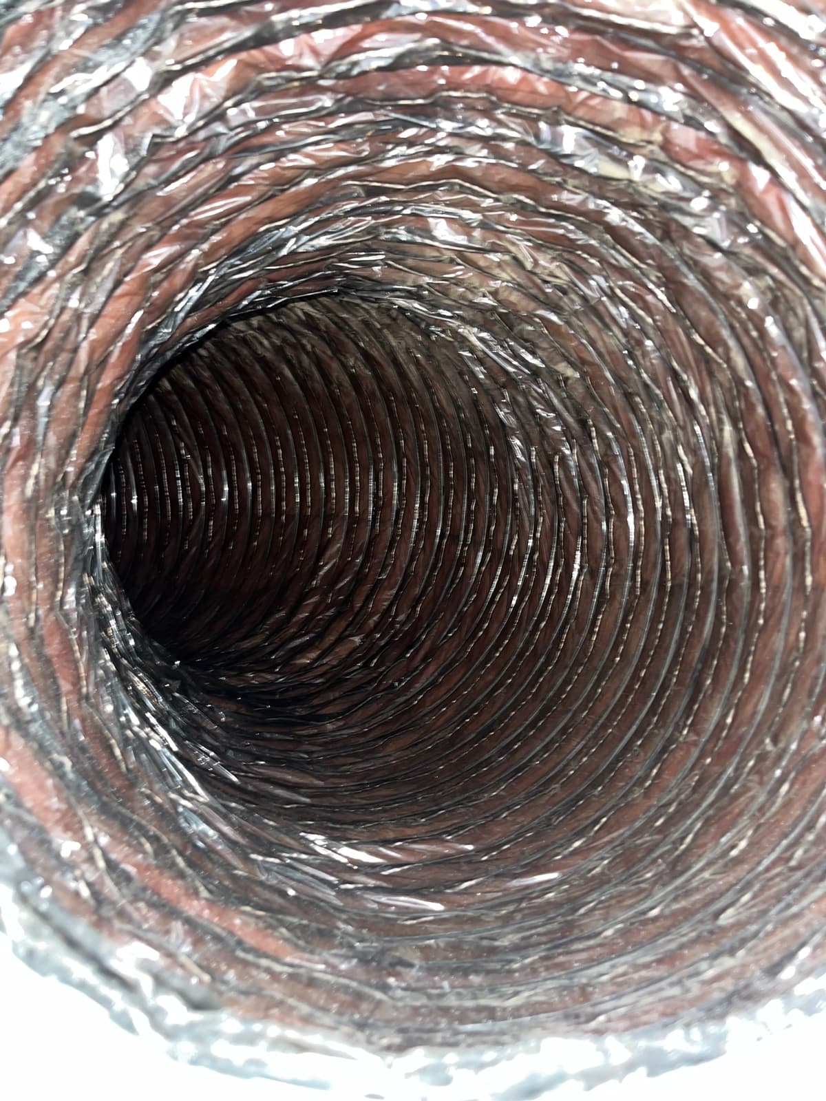 The same duct after cleaning, showing the clean liner