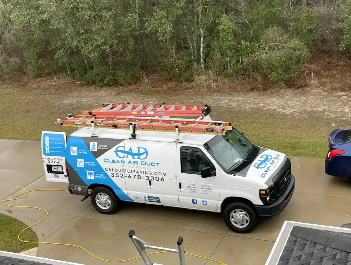 A Clean Air Duct Cleaning van parked in a commercial parking lot