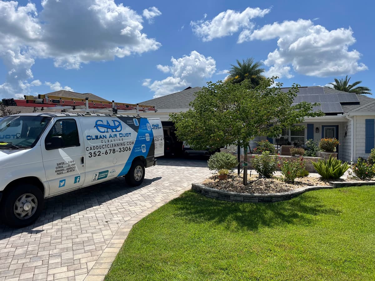 A Clean Air Duct Cleaning van parked outside a single-storey Central Florida ranch home