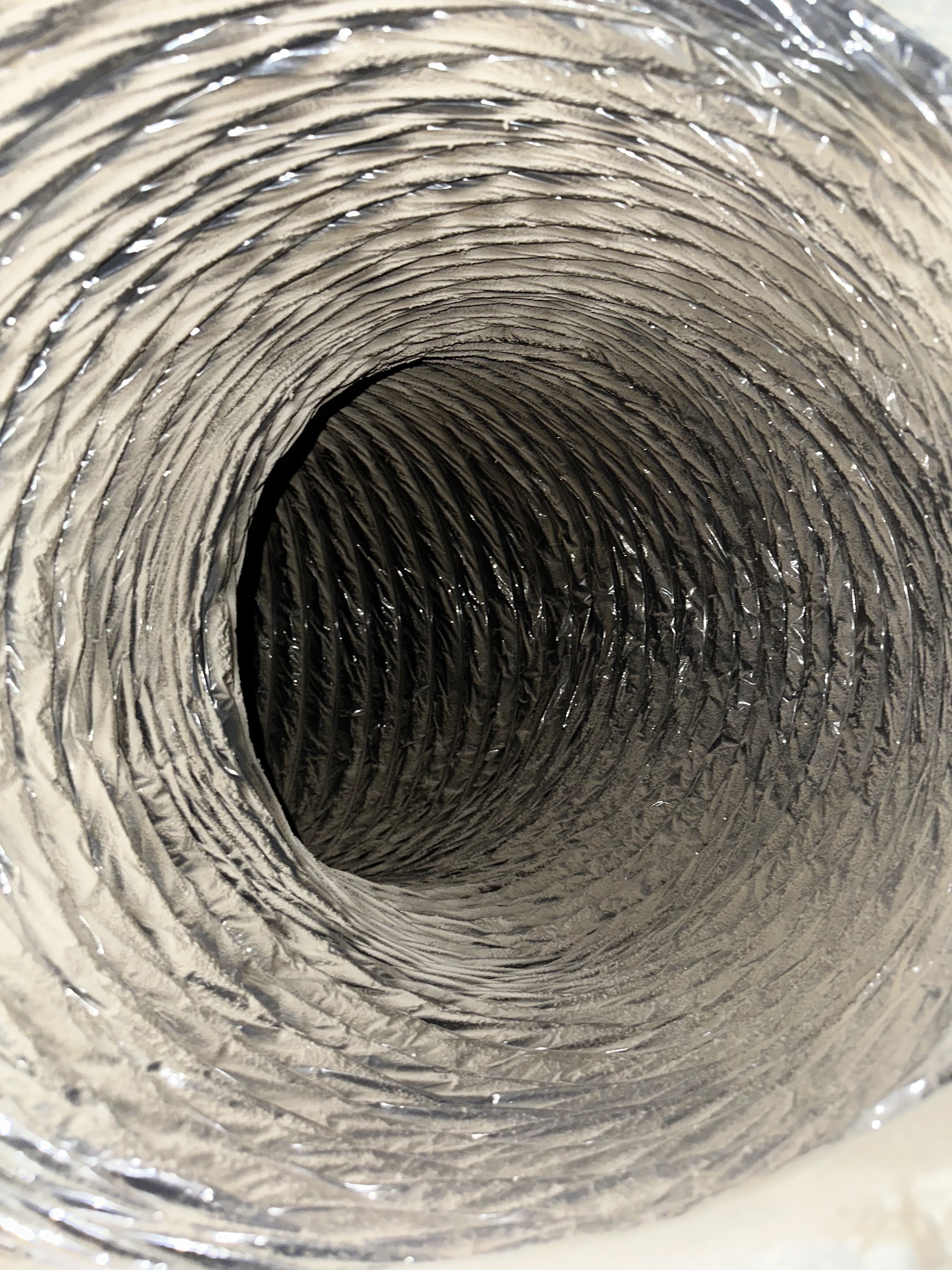 The same flexible air duct after NADCA-standard source removal cleaning, back to bare surface