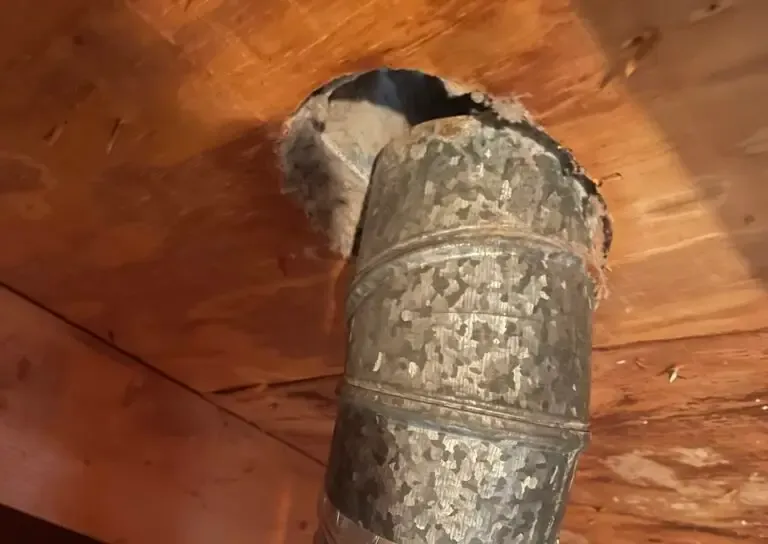 Supply vent and duct boot before cleaning, lined with dust
