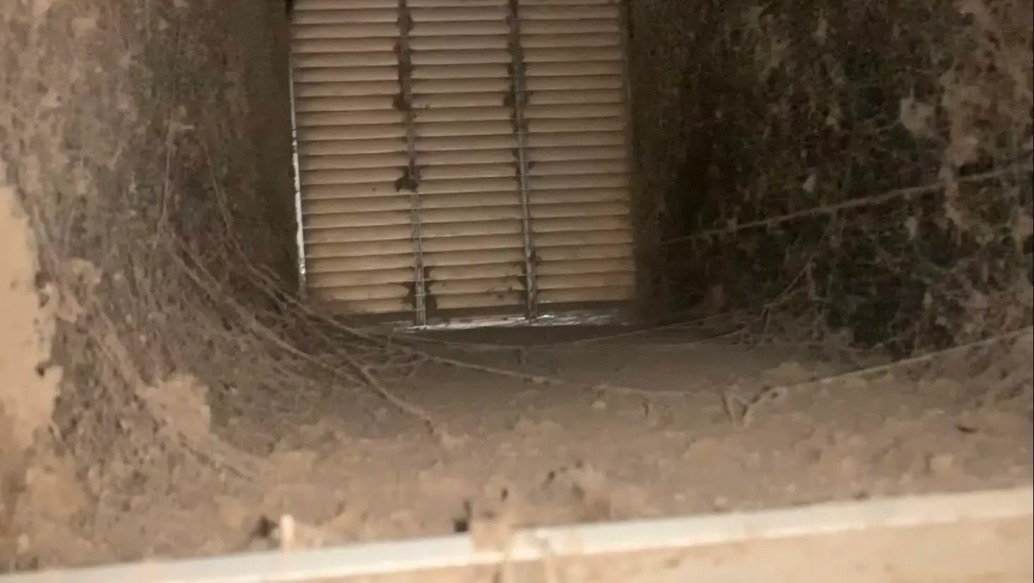 Dust and debris packed inside a duct run before cleaning
